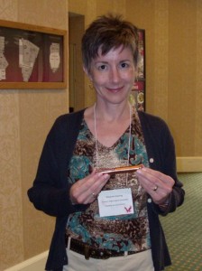 SMCR_pres20090606 New President Kissling displays the prized bronze tampon, by tradition passed to the incoming president at the biannual meeting.