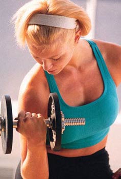 Image of slender white woman doing bicep curls with small barbell.